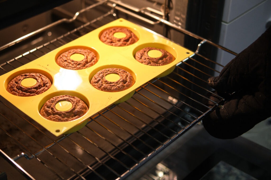 Homemade donuts cooking in their mold in the oven