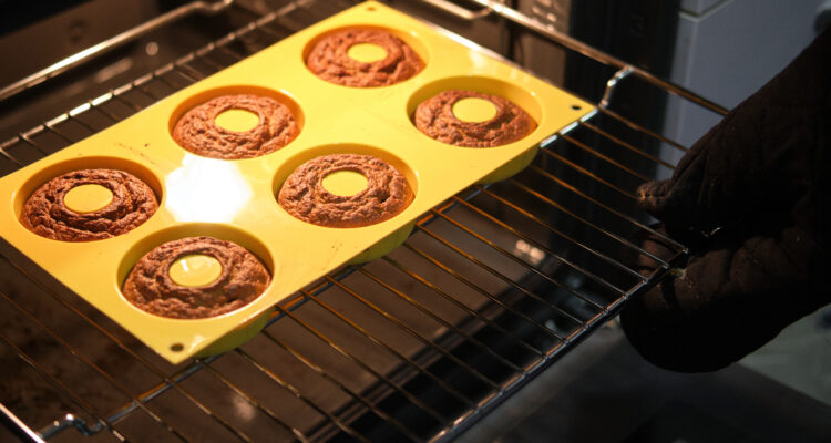 Homemade donuts cooking in their mold in the oven