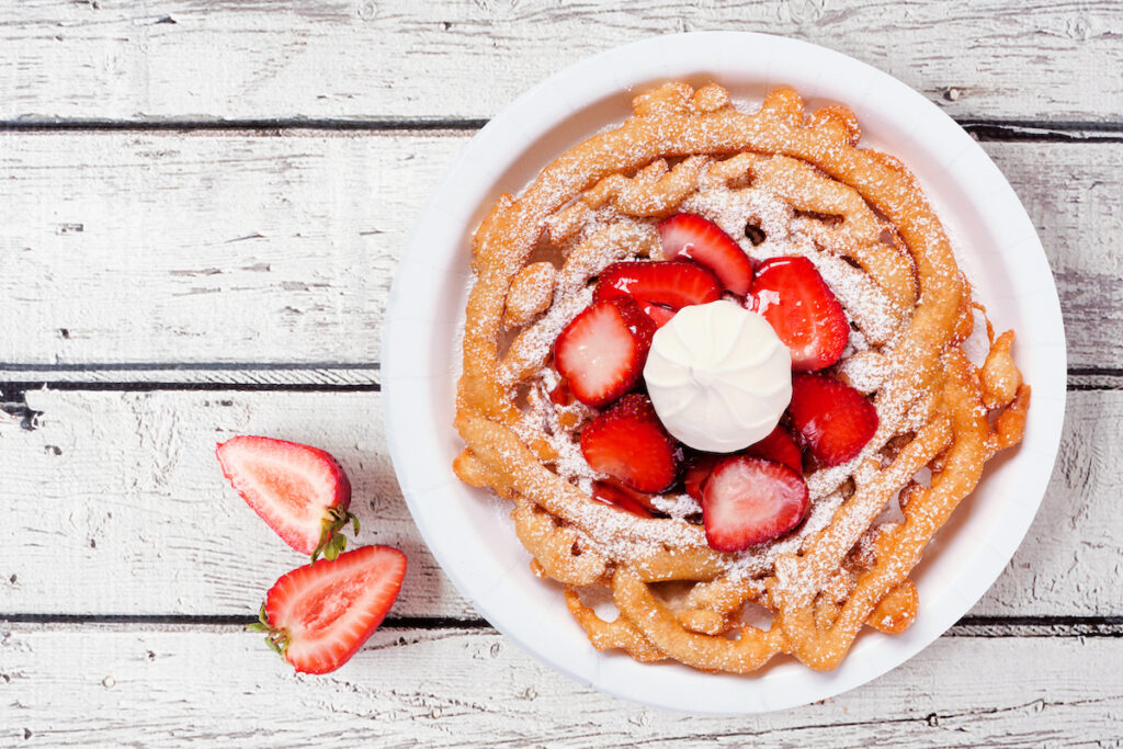 Funnel cake with strawberries and cream